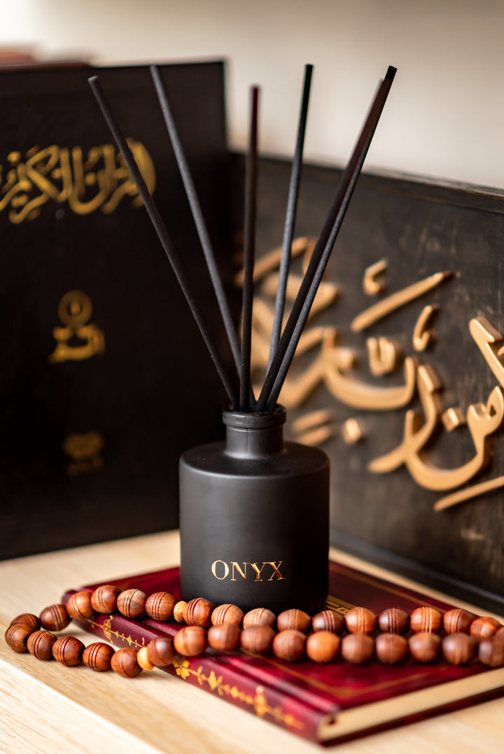 Nūr ‘ala Nūr candle on hadith books with prayer beads