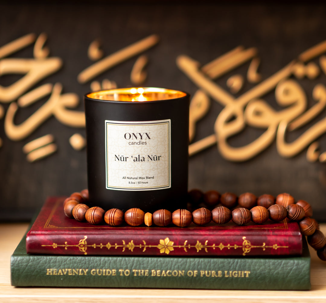 Onyx reed diffuser and lit Nūr ‘ala Nūr candle