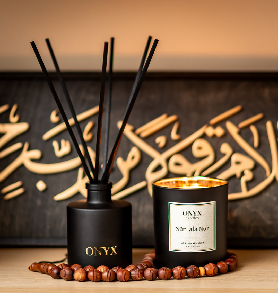 Nūr ‘ala Nūr candle lit close-up against calligraphy